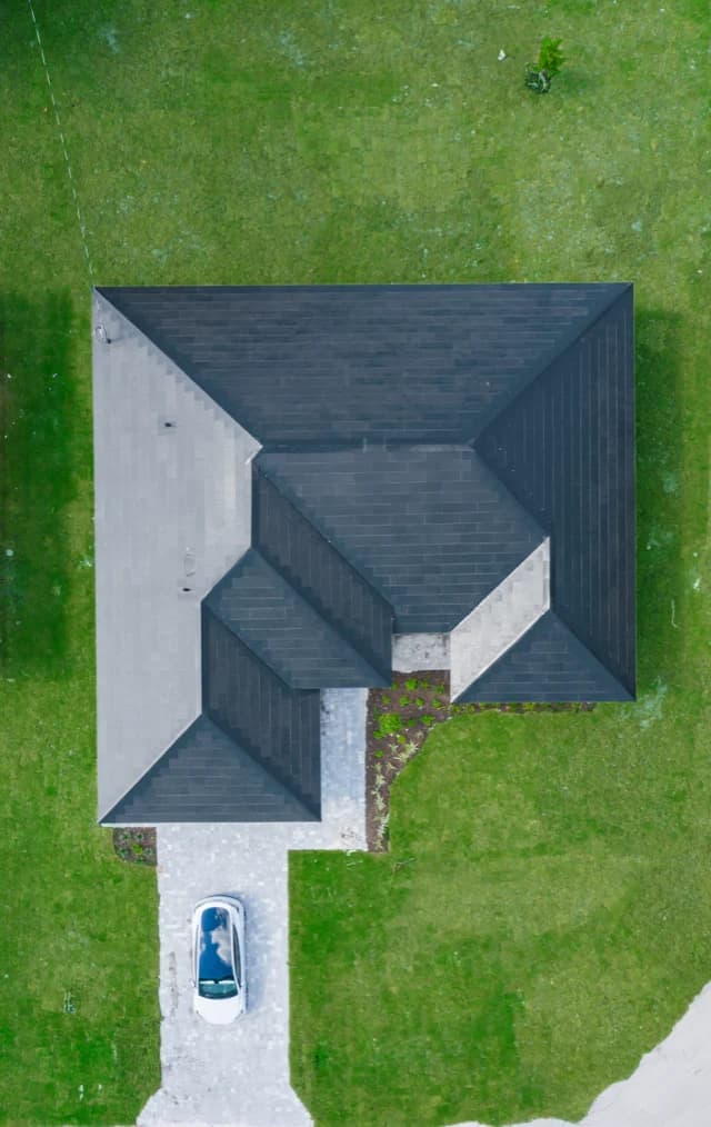 Top-down aerial showing complete Tesla Solar Roof coverage